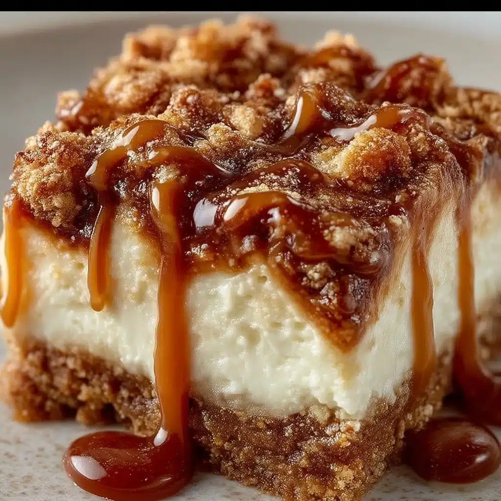 Delicious caramel apple cheesecake bars topped with caramel drizzle and apple slices.