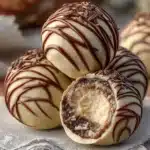 Baileys cheesecake balls displayed on a white platter